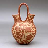 A red wedding vase decorated with a sgraffito hummingbird, butterfly, flower, leaf, branch and geometric design, click or tap to see a larger version