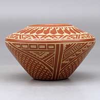 A red on buff jar decorated with a sgraffito snowflake, feather and geometric design, click or tap to see a larger version