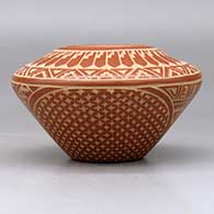 A red on buff jar decorated with a sgraffito snowflake, feather and geometric design, click or tap to see a larger version