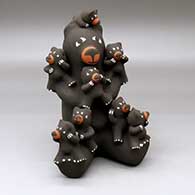 A sitting bear storyteller figure with eight cubs
 by Antoinette Concha of Jemez