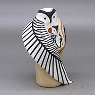 An owl storyteller figure wearing a manta with one chick
 by Loren Wallowing Bull of Jemez