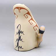 A sitting grandmother storyteller wearing a manta with four children, a drum and a welcome basket, click or tap to see a larger version