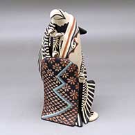 Click for a larger view A standing eagle storyteller with four chicks and a blanket
 by Loren Wallowing Bull of Jemez