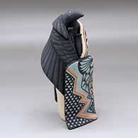 A standing raven storyteller figure with three chicks and a blanket
 by Loren Wallowing Bull of Jemez