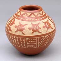 A red jar decorated around the body with a sgraffito avanyu, turtle, feather and geometric design
 by Alvina Yepa of Jemez