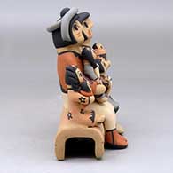 A grandparent storyteller figure with three children, click or tap to see a larger version