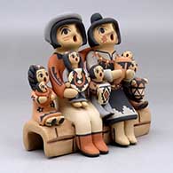 A grandparent storyteller figure with three children, click or tap to see a larger version