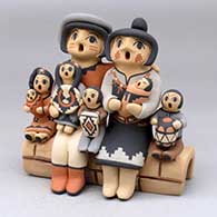 Click for a larger view A grandparent storyteller figure with three children
 by Chrislyn Fragua of Jemez