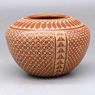 A red jar decorated with a four panel sgraffito snowflake, feather and geometric design
 by Wilma Baca Tosa of Jemez