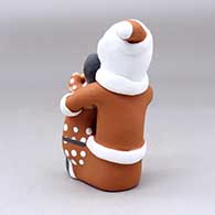 A sitting Santa Claus storyteller figure with two children and gifts, click or tap to see a larger version