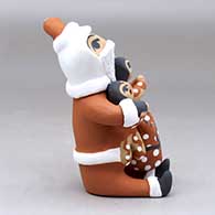 A sitting Santa Claus storyteller figure with two children and gifts, click or tap to see a larger version