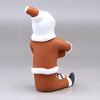 A sitting Santa Claus storyteller figure with two children and gifts, click or tap to see a larger version