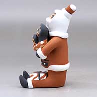 A sitting Santa Claus storyteller figure with two children and gifts, click or tap to see a larger version