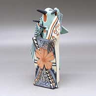 A standing hummingbird storyteller figure with three chicks and a blanket
 by Loren Wallowing Bull of Jemez