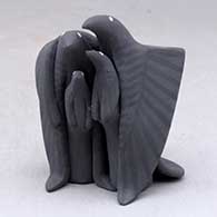 A polychrome standing raven couple with two chicks
 by Loren Wallowing Bull of Jemez