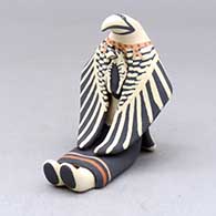 A sitting eagle storyteller with one chick
 by Loren Wallowing Bull of Jemez