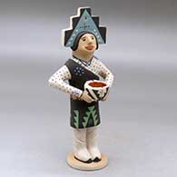 A standing Pueblo dancer figure wearing a tablito and holding a pot
 by Benjamin Fragua of Jemez