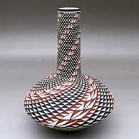 A polychrome vase decorated with a spiral mesa geometric design
 by Robert Kasero Sr of Laguna