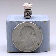 A miniature black-on-white two-opening jar decorated with a geometric design, click or tap to see a larger version