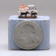 A miniature polychrome two-opening jar decorated with an animal and geometric design, click or tap to see a larger version