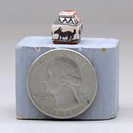 A miniature polychrome two-opening jar decorated with an animal and geometric design, click or tap to see a larger version