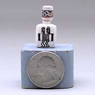 A miniature lidded three-sided jar decorated with a Mimbres figure and geometric design, click or tap to see a larger version