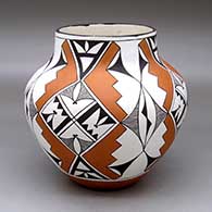 A polychrome jar decorated around the body with an eight-panel geometric design
 by Lee Ann Cheromiah of Laguna