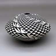 A black on white seed pot decorated with a spiral mesa and geometric design, click or tap to see a larger version