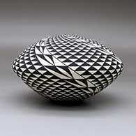 A black on white seed pot decorated with a spiral mesa and geometric design, click or tap to see a larger version