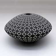A black on White seed pot decorated with a geometric design, click or tap to see a larger version