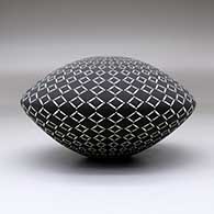 A black on White seed pot decorated with a geometric design, click or tap to see a larger version