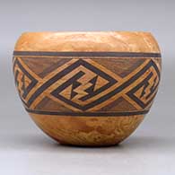 A polychrome mixed clay bowl decorated with a band of fineline and geometric design around the body, click or tap to see a larger version