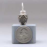 A miniature black on white jar decorated with an ancient Mogollon geometric design and with a cutout in the lid, click or tap to see a larger version