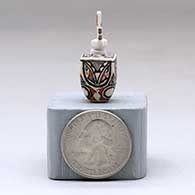 A miniature polychrome square jar decorated with a geometric design and a tablito lid, click or tap to see a larger version