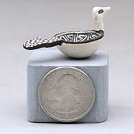 A miniature black on white bird bowl decorated with a Mimbres and geometric design, click or tap to see a larger version