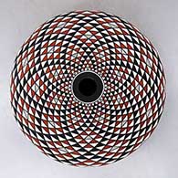 A polychrome seed pot decorated with a spiral mesa geometric design
 by Robert Kasero Sr of Laguna