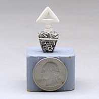 A miniature black on white lidded rectangular jar with a cutout in the lid and and decorated with a fineline and geometric design, click or tap to see a larger version