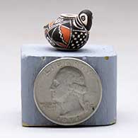 A miniature polychrome bird effigy pot decorated with a geometric design, click or tap to see a larger version