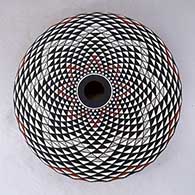 A polychrome seed pot decorated with a spiral mesa geometric design, click or tap to see a larger version