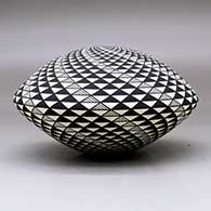 A black on white seed pot decorated with a spiral mesa geometric design, click or tap to see a larger version
