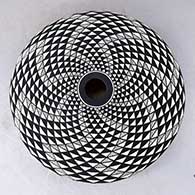 A black on white seed pot decorated with a spiral mesa geometric design, click or tap to see a larger version