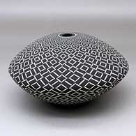 A black on White seed pot decorated with a geometric design
 by Robert Kasero Sr of Laguna