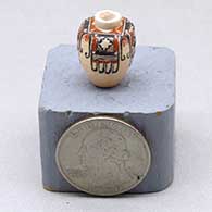 A miniature polychrome jar decorated with a four panel eagle tail and geometric design
 by Thomas Natseway of Laguna