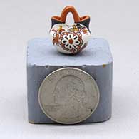 A miniature polychrome wedding vase decorated with a rosette, bird and geometric design
 by Thomas Natseway of Laguna