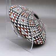 A polychrome seed pot decorated with a spiral mesa geometric design top and bottom, click or tap to see a larger version