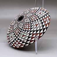 A polychrome seed pot decorated with a spiral mesa geometric design top and bottom, click or tap to see a larger version