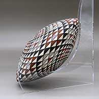 A polychrome seed pot decorated with a spiral mesa geometric design top and bottom, click or tap to see a larger version