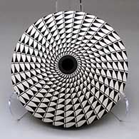 A black on white seed pot decorated with a spiral mesa geometric design top and bottom
 by Robert Kasero Sr of Laguna