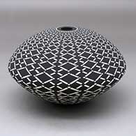 A black on White seed pot decorated with a geometric design
 by Robert Kasero Sr of Laguna