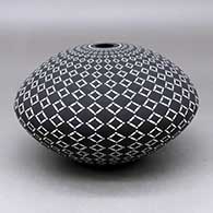 A black on White seed pot decorated with a geometric design
 by Robert Kasero Sr of Laguna